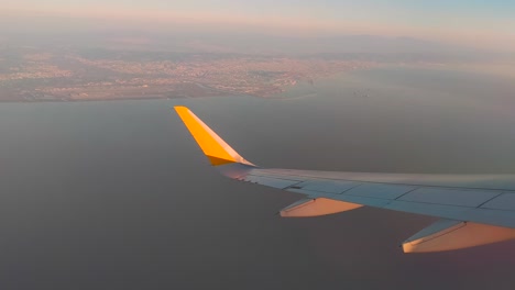 airplane wing on the horizon line and the port on the way to marseille with the ships in the sea