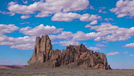 a beautiful time lapse behind a rock formation near monument valley