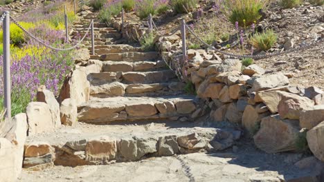 Tourist-Walking-Up-the-Stairs-Exploring-Cobblestone-Steps-in-Sunny-Holiday-Destination,-Point-of-View