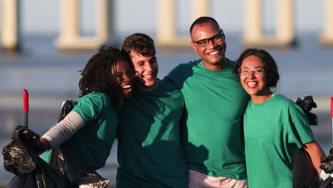 Happy-volunteers-hugging-in-park