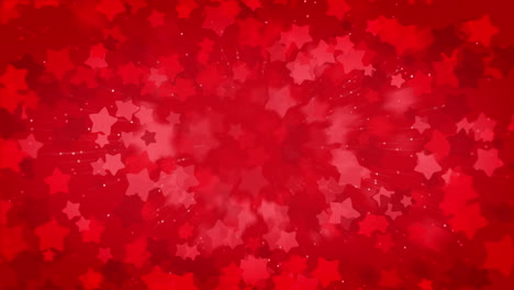 abstract animated explosion of red stars. blurred festive looping background with empty space for text.