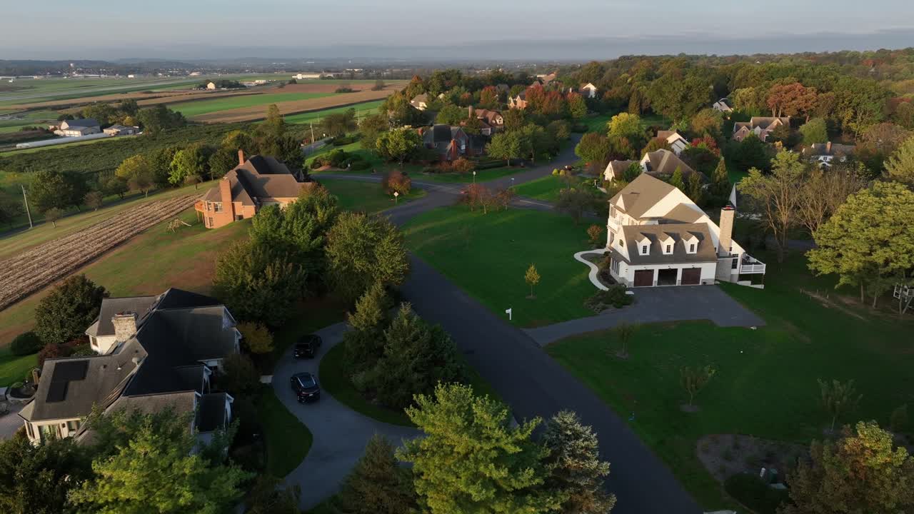 Luxury and noble villas in rural landscape area of american countryside. Large properties on top of hills. Farmland fields in distance. Aerial flyer shot. Peaceful and quaint district of USA