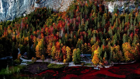 lakefront cabins amidst autumn trees on the shore of lake toplitz in austria