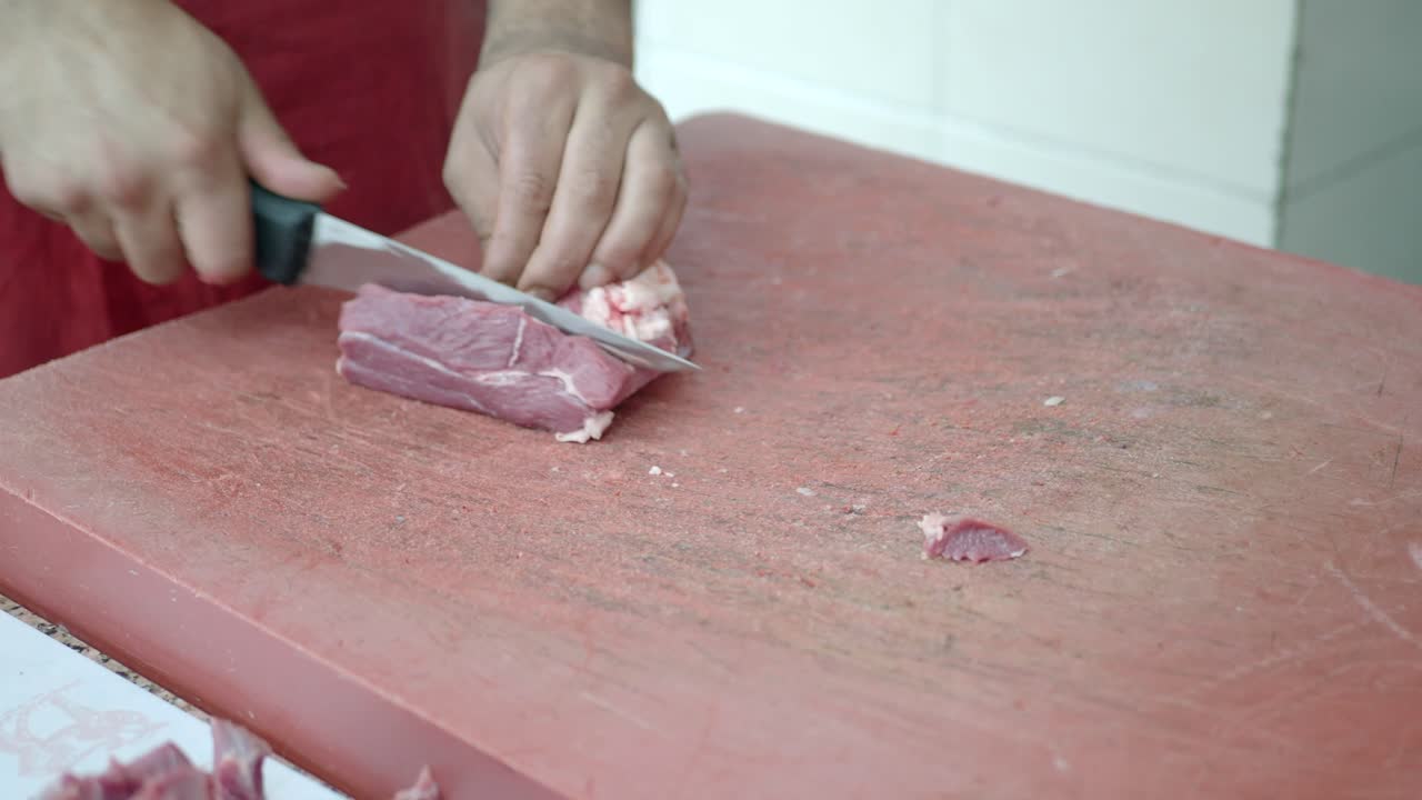 Butcher Cutting Raw Beef