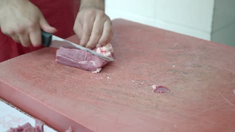 butcher cutting raw beef