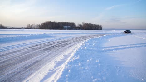 car driving on a snowy frozen road