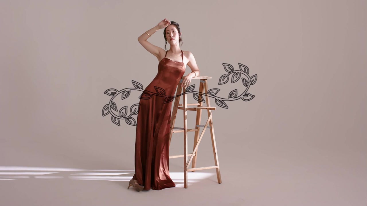 Model entering from left, posing on ladder for fashion editorial vine crossing waist moving shadows