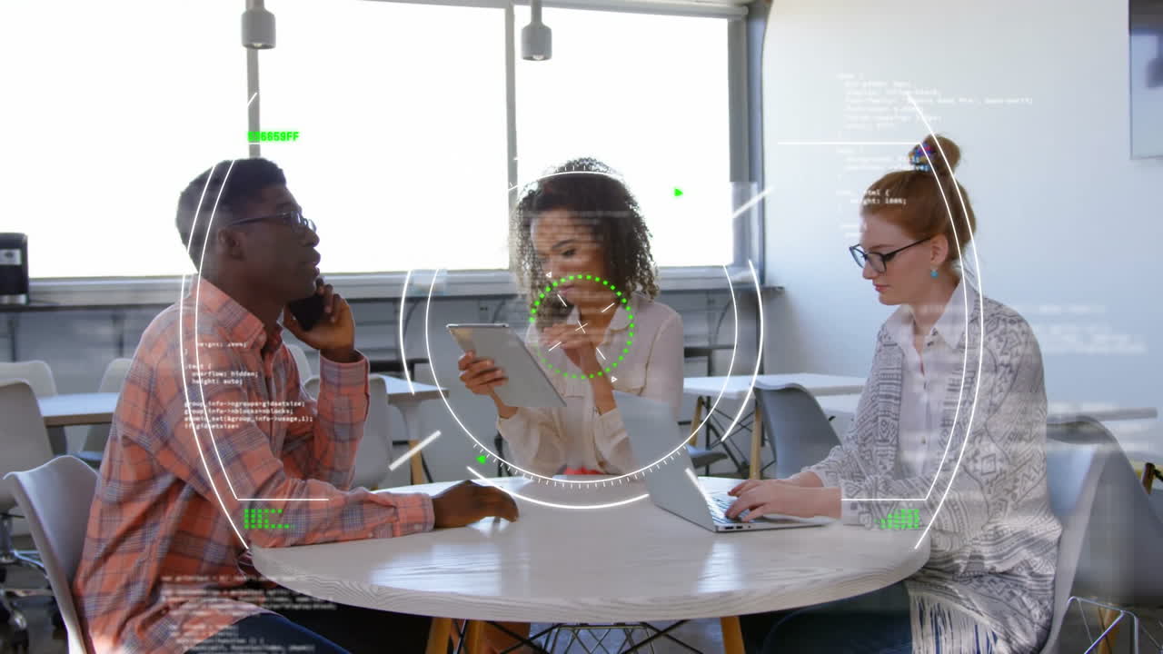 Diverse colleagues working at table with digital data processing animation overlay