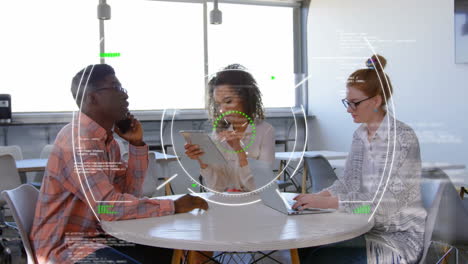 diverse colleagues working at table with digital data processing animation overlay