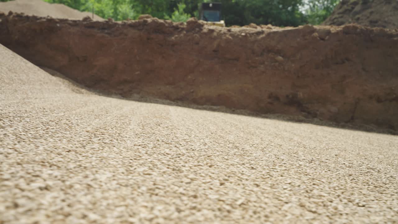 Low angle view of smooth gravel base compacted for backyard pool install