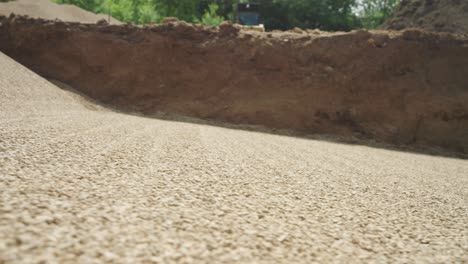 low angle view of smooth gravel base compacted for backyard pool install