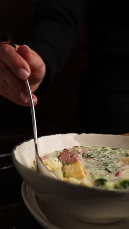 woman eating cold soup (okroshka)