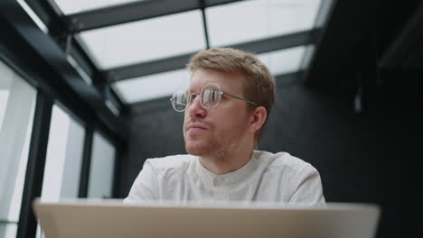 architect-is-working-in-his-studio-with-laptop-thinking-about-design-and-architecture-portrait-shot