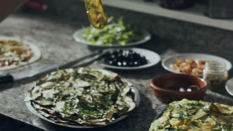 preparing vegetarian pizza in restaurant kitchen