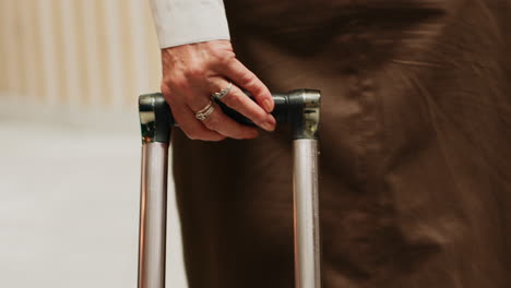 older woman carries trolley bags