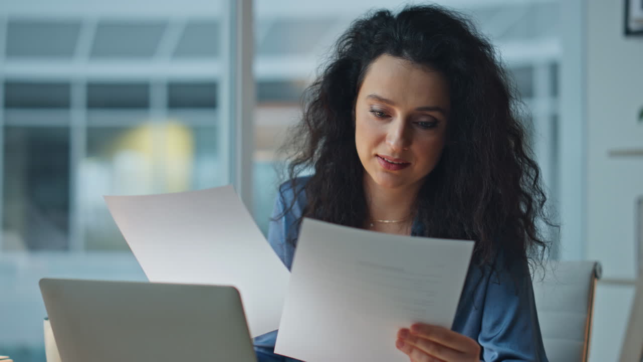 Productive woman working late in office closeup. Smiling manager checking papers