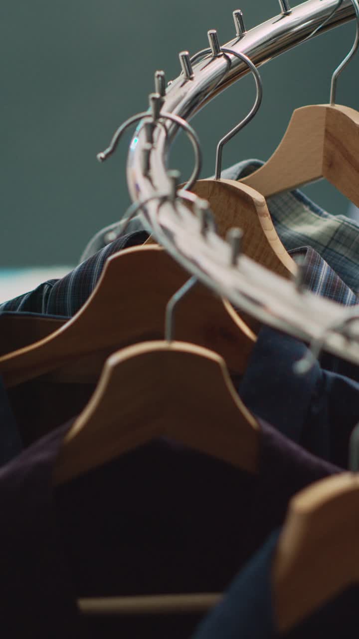 Vertical video: Empty clothes market filled with racks and hangers