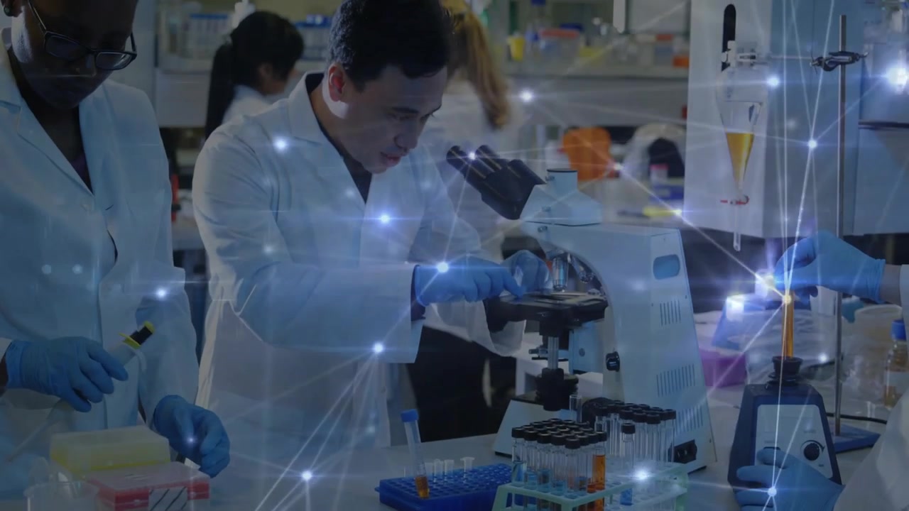 Lead researcher placing slide, focusing for exam, team prepping tubes, overlay marking nodes