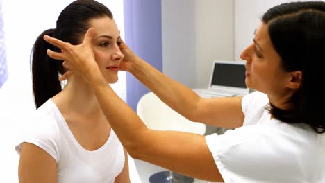 doctor examining female patient skin