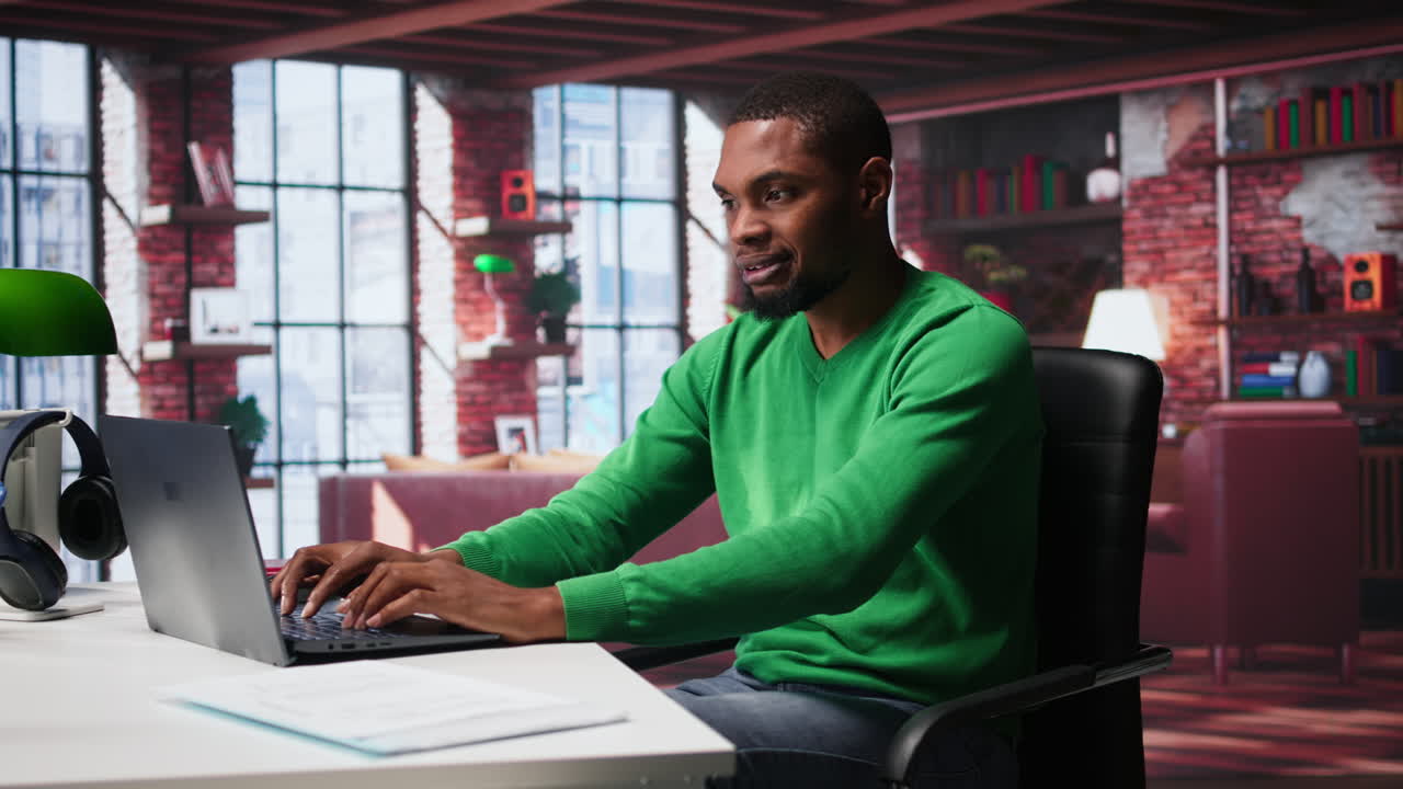 Vertical Video Black man doing remote work feeling uneasy and anxious at desk