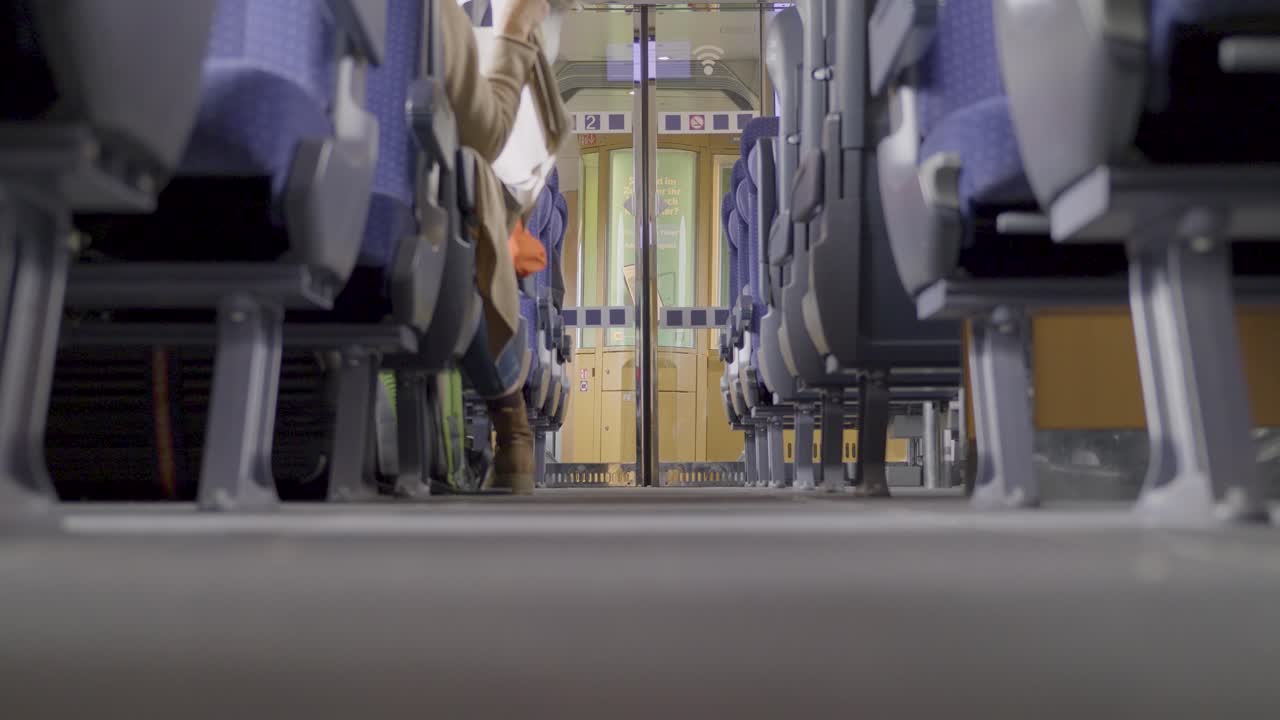 Interior of a German ICE high-speed train with seats in focus, empty aisle