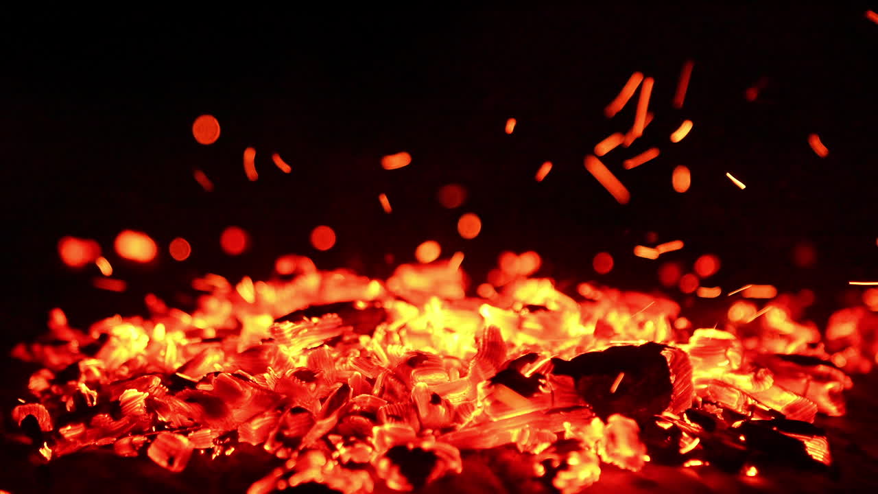 Burning logs close up view. Red flaming on a firewood.