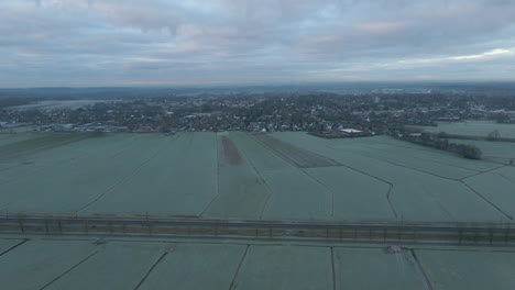 Aerial-of-distant-town-in-a-beautiful-Dutch-rural-landscape