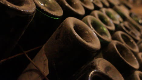 stacked wine bottles in cellar