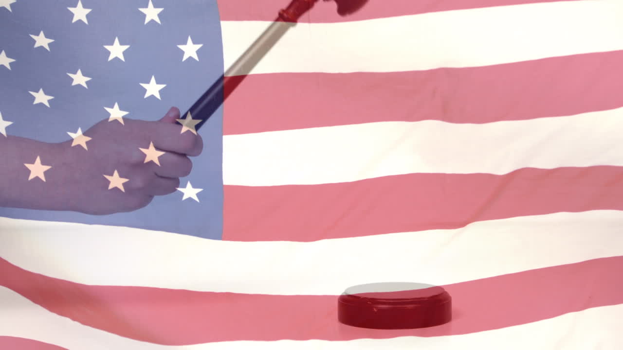 Composite video of waving american flag against hand banging a gavel