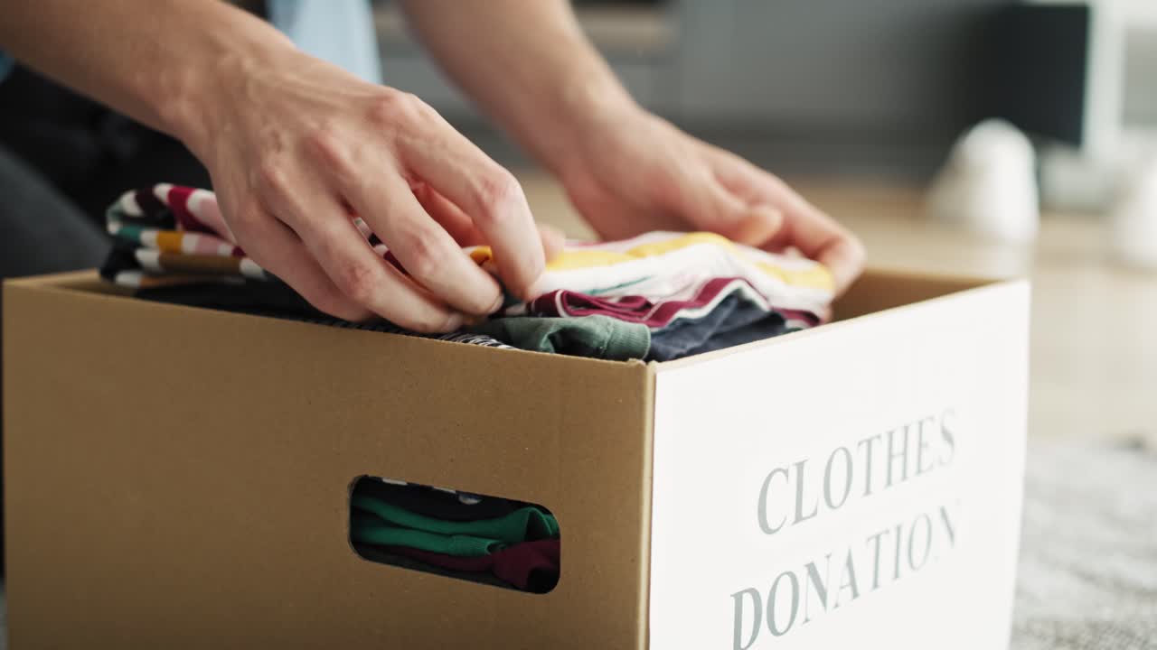 Tracking video of preparing clothes for donation