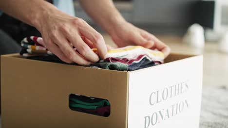 tracking video of preparing clothes for donation