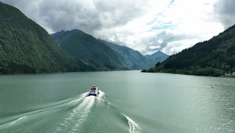 glacier tour boat sailing down fjaerlandsfjorden fjord, norway