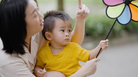 asian kid with his mother in a park