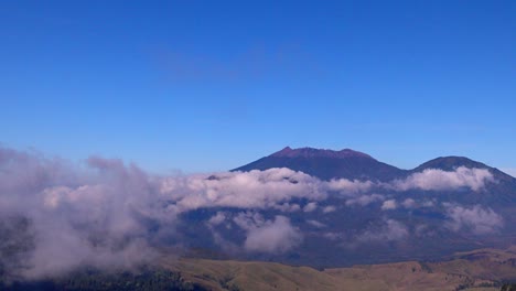 view of mount raung with clouds surrounding seen from mount ijen, banyuwangi, east java, indonesia