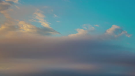 gray dramatic clouds flowing and revealing blue sky, time lapse