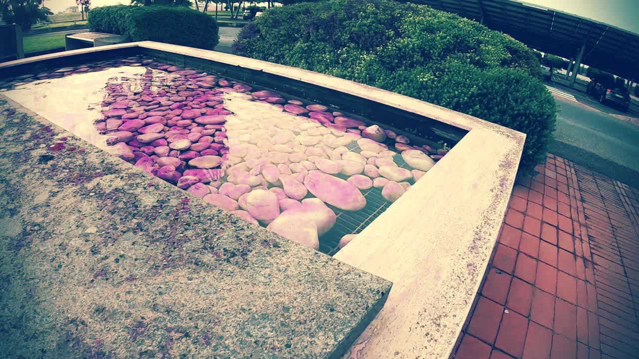 water rock pool fountain in Italy green and purple rocks