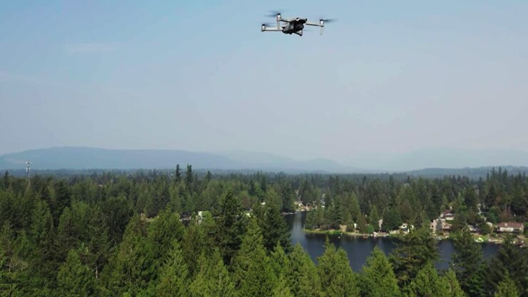 Drone Flying Above Coniferous Trees At Pipe Lake In Covington, Washington State, United States
