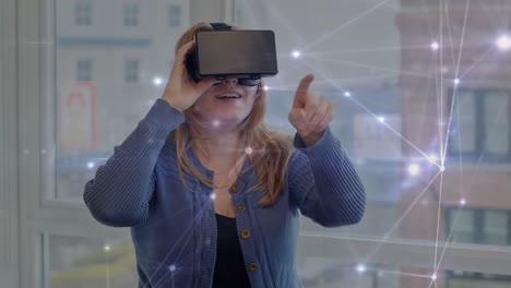 animation of network of connections over caucasian woman wearing vr headset