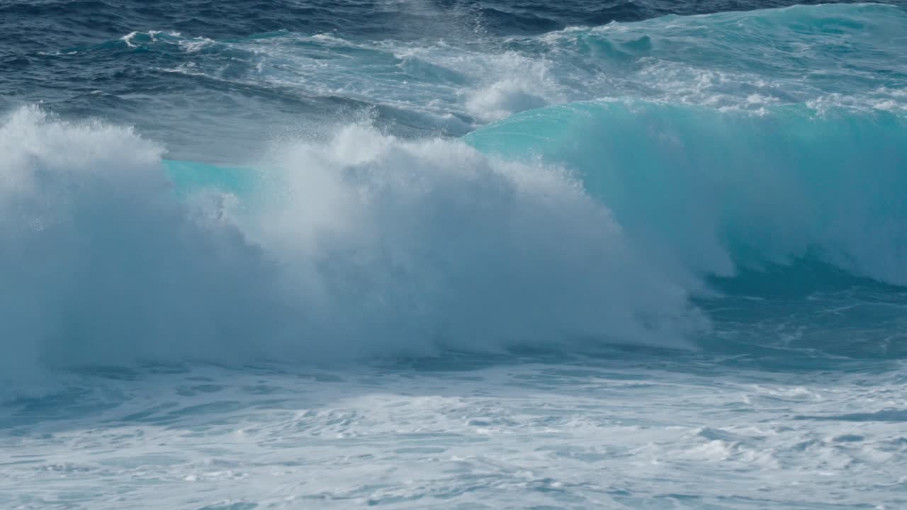 Dramatic ocean waves collide with the volcanic coastline near Timanfaya National Park, located on the island of Lanzarote in the Canary Islands, Spain.