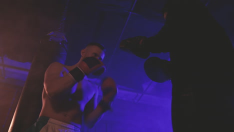 Shirtless-Boxer-Man-Warms-Up-By-Punching-The-Sparring's-Gloves-1