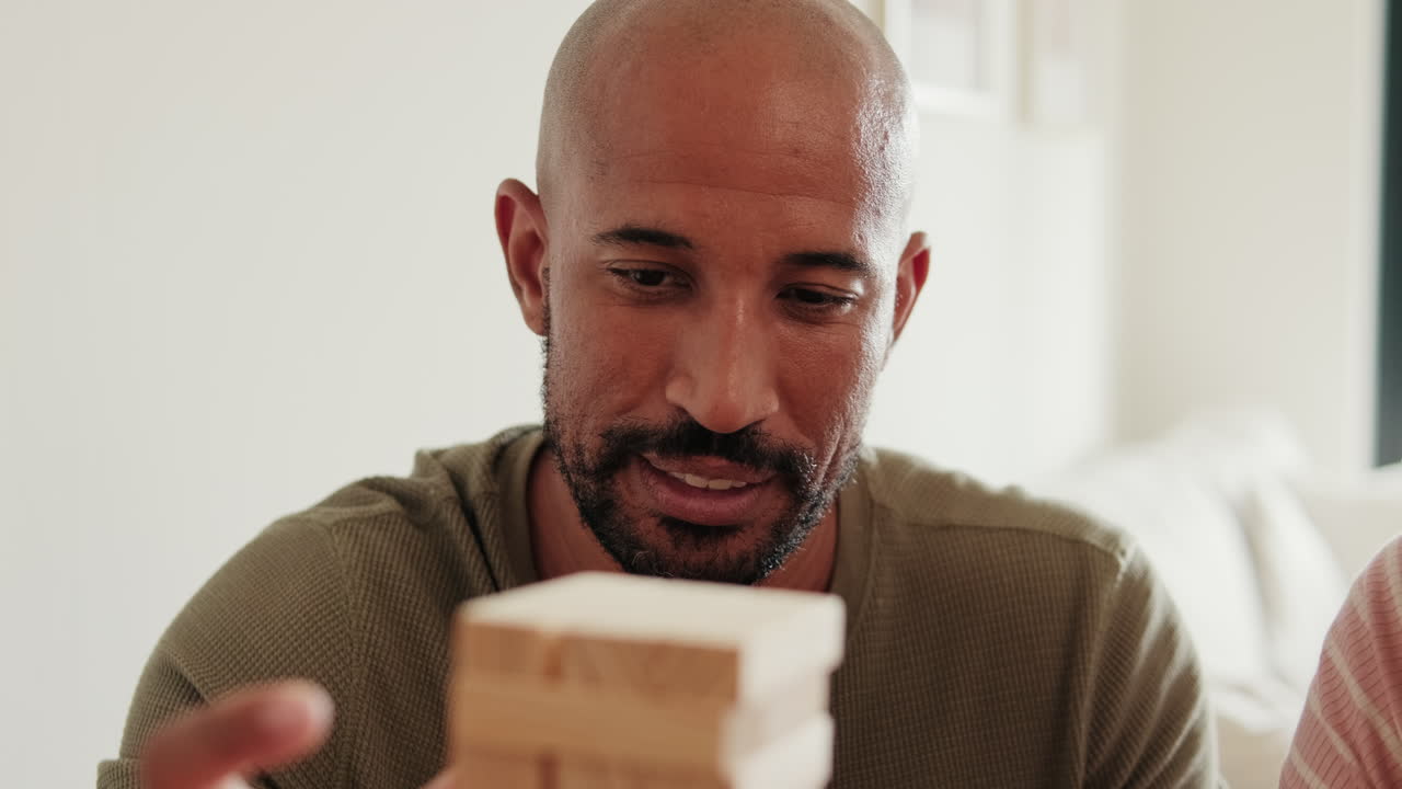 Couple Playing Jenga and Having Fun at Home