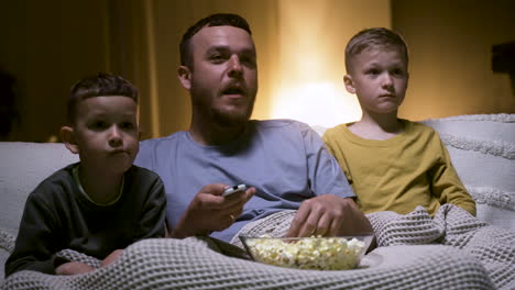 father and sons watching film