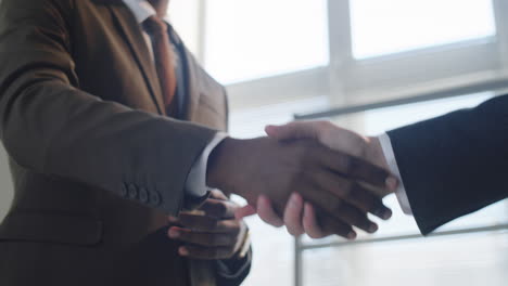 black businessman giving handshake to colleague in office