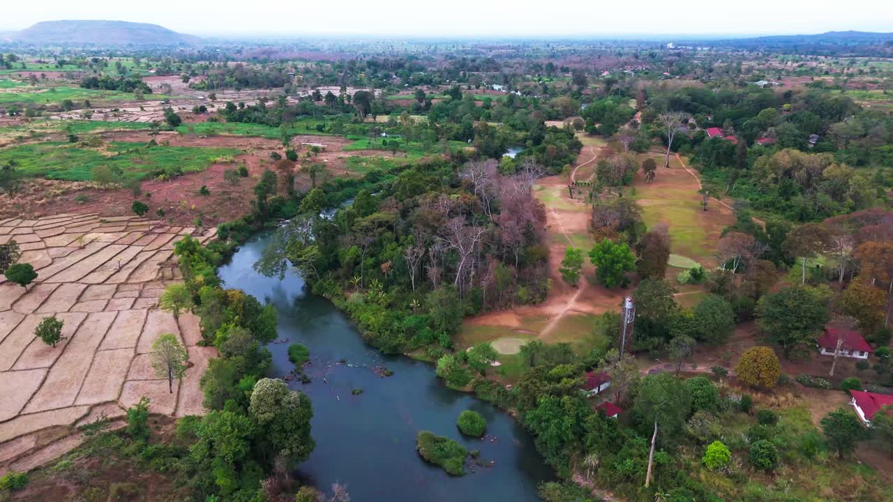 Aerial fly lush coffee agricultural plantations at Bolaven Plateau Laos, river Mekong around Local Village part of Pakse motorcycle Loop
