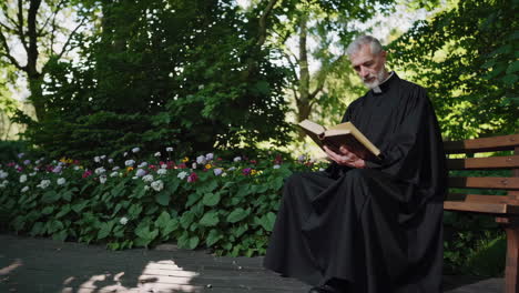 priest reading in a park