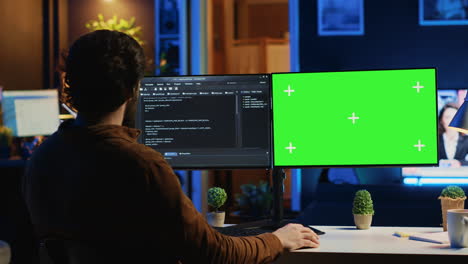 self employed man doing it support job, coding on green screen pc
