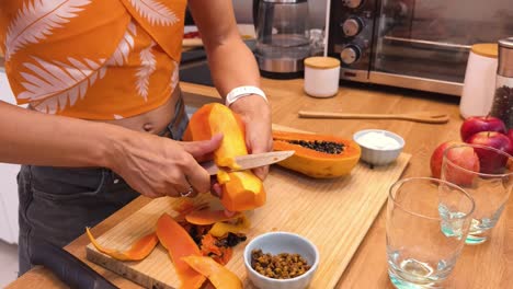 woman peeling a papaya