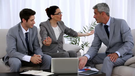 group of business people gesturing during a meeting
