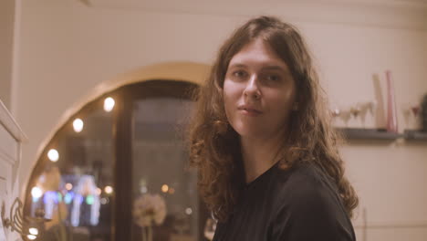 beautiful female pianist looking and smiling at camera at restaurant