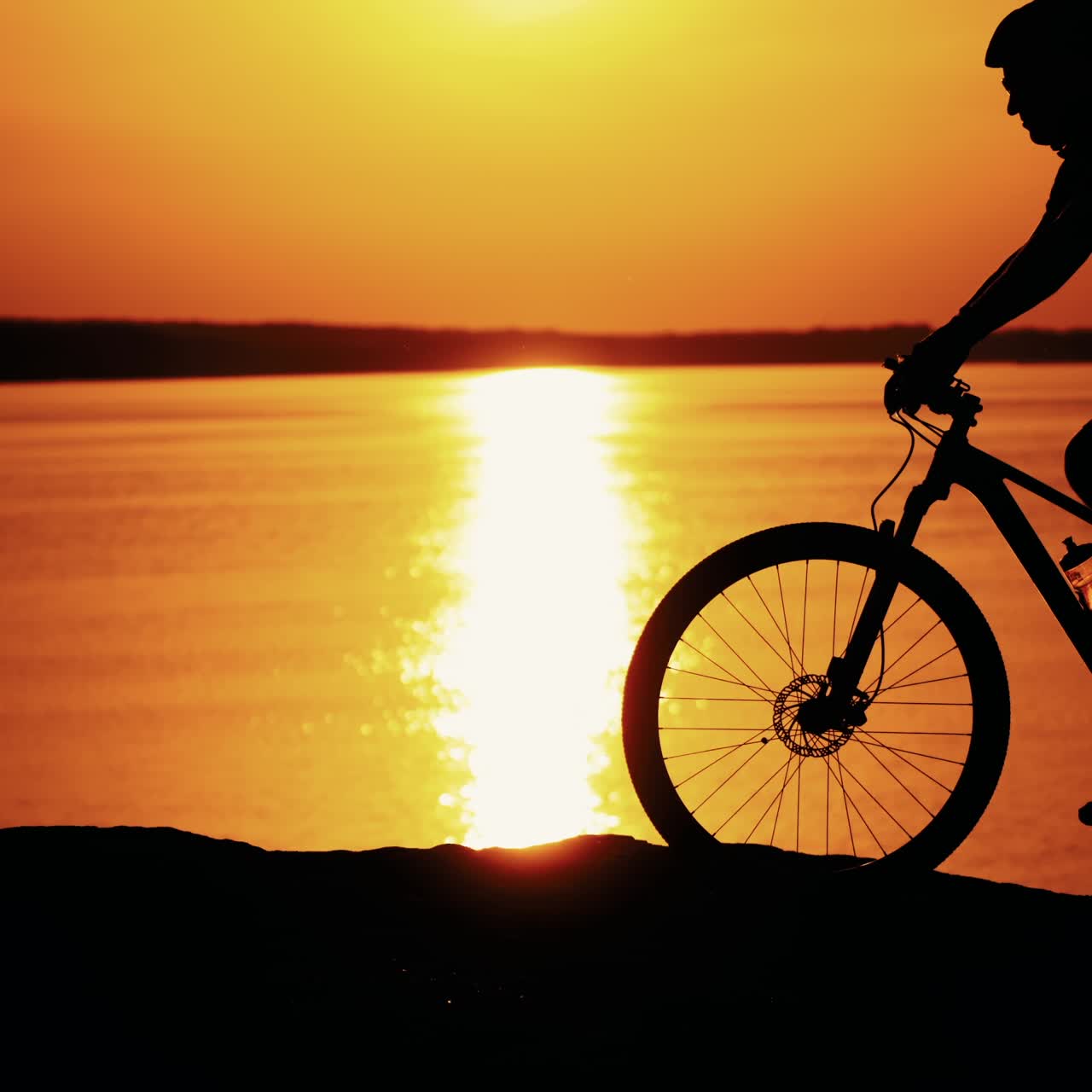 Man ride a bicycle at sunset